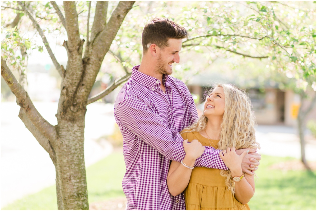 Engagement session in blooming cherry tree blossoms | Downtown Spartanburg Engagement Session | Jacqueline & Laura