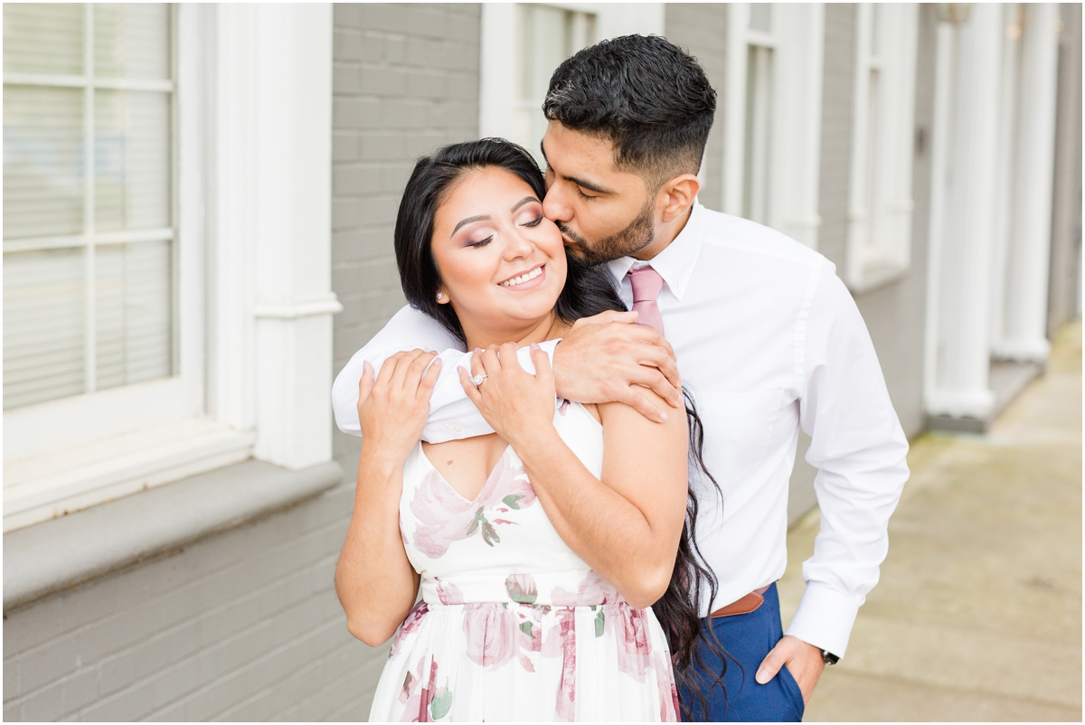 Classy Downtown Greenville Engagement Session by gray wall with blush & navy outfits