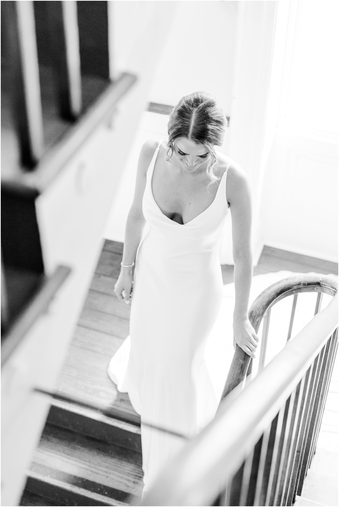 Bride walking down stairs at William Aiken House Wedding in Downtown Charleston