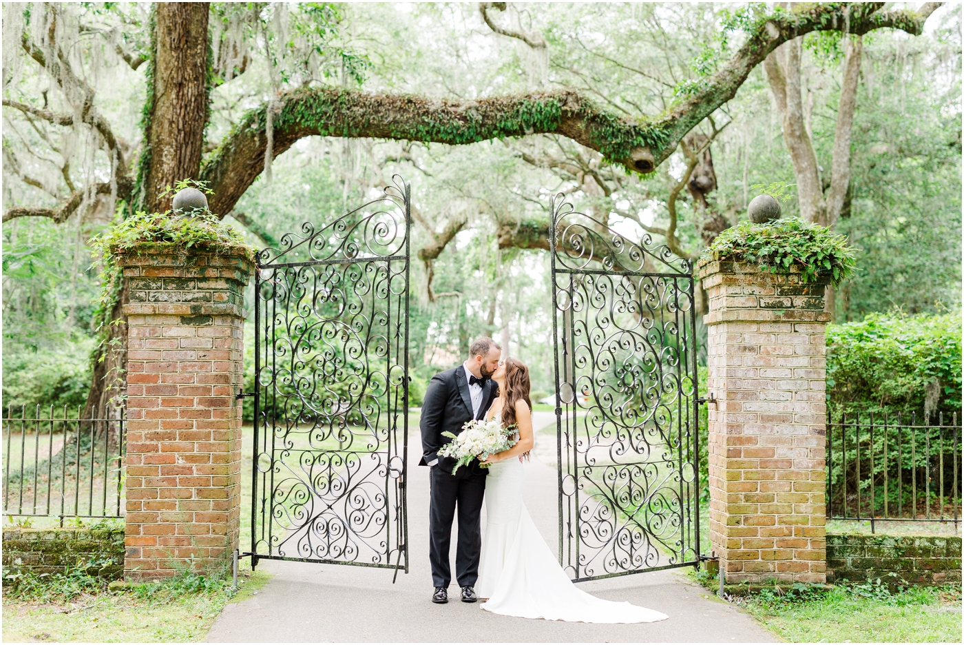 bride and groom photos in front of gate at Legare Waring House in Charleston, SC