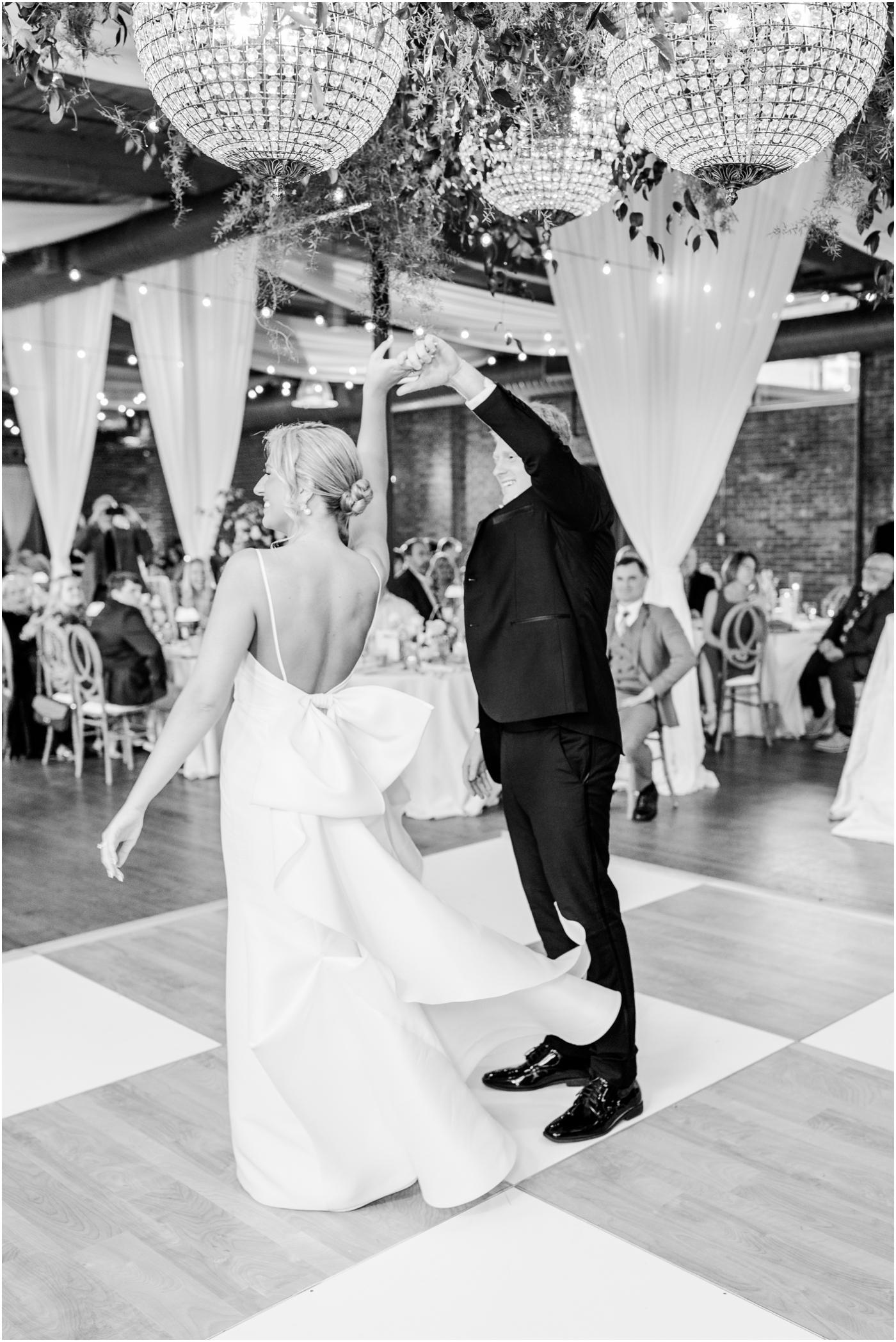 Groom spins bride on dance floor at their Huguenot Loft Wedding