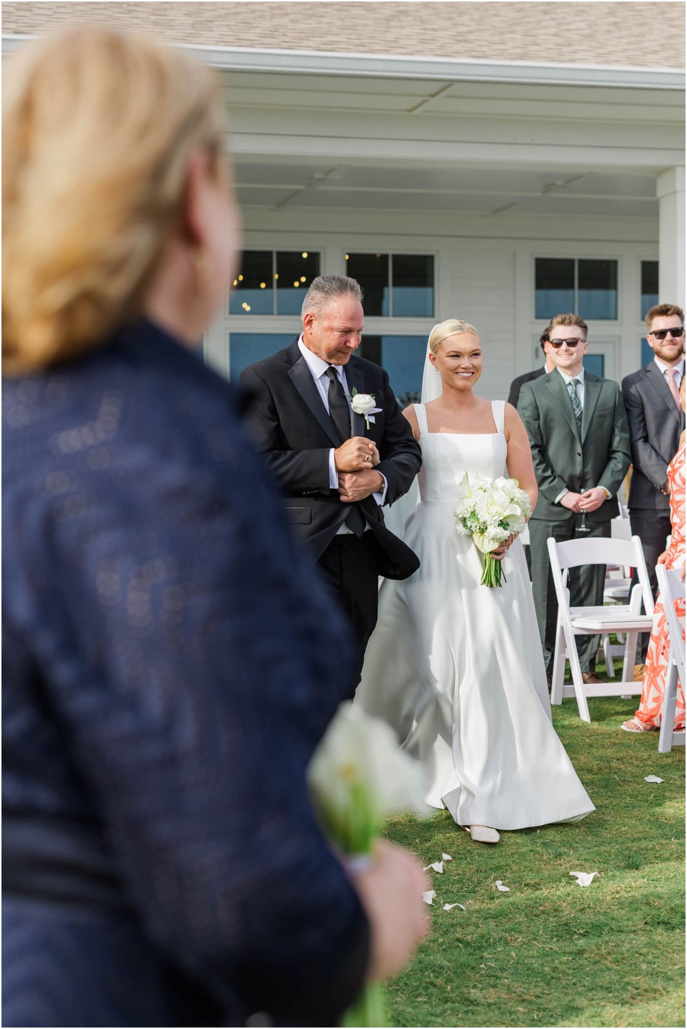 bride walking down aisle at the coral bay club