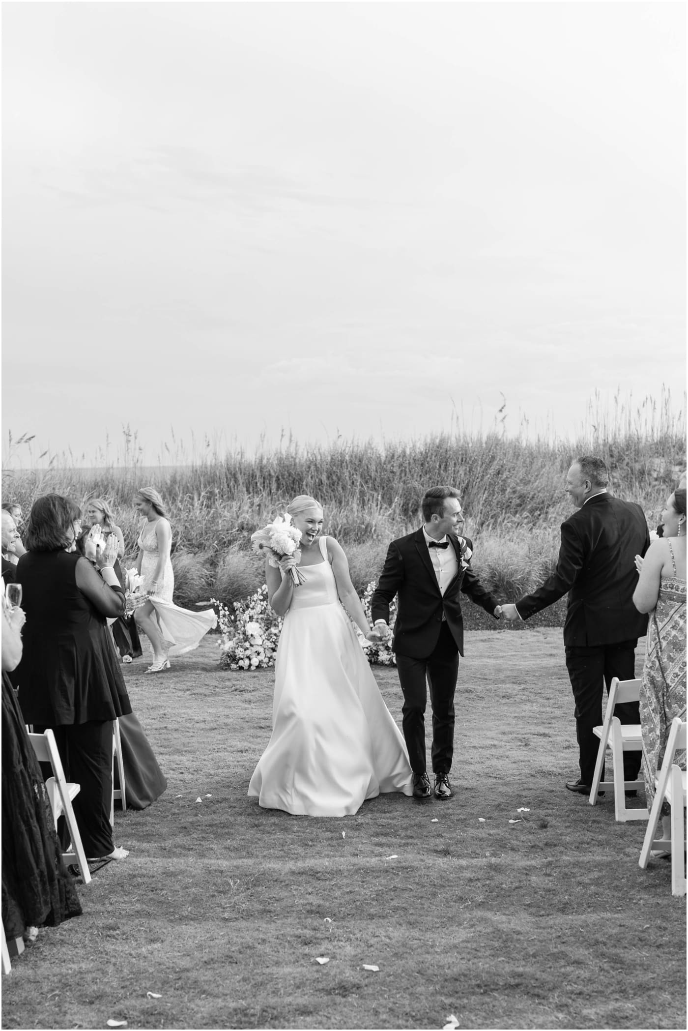 bride and groom cheering as they exit ceremony at coral bay club 