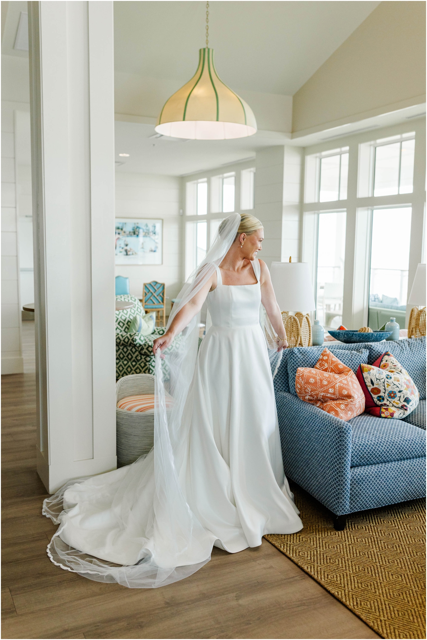 bride showing off wedding dress inside coral bay club in Atlantic Beach