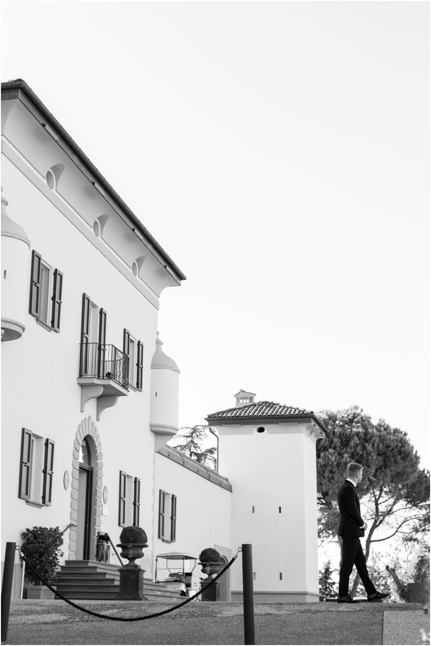 black and white photo of groom waiting to walk down aisle