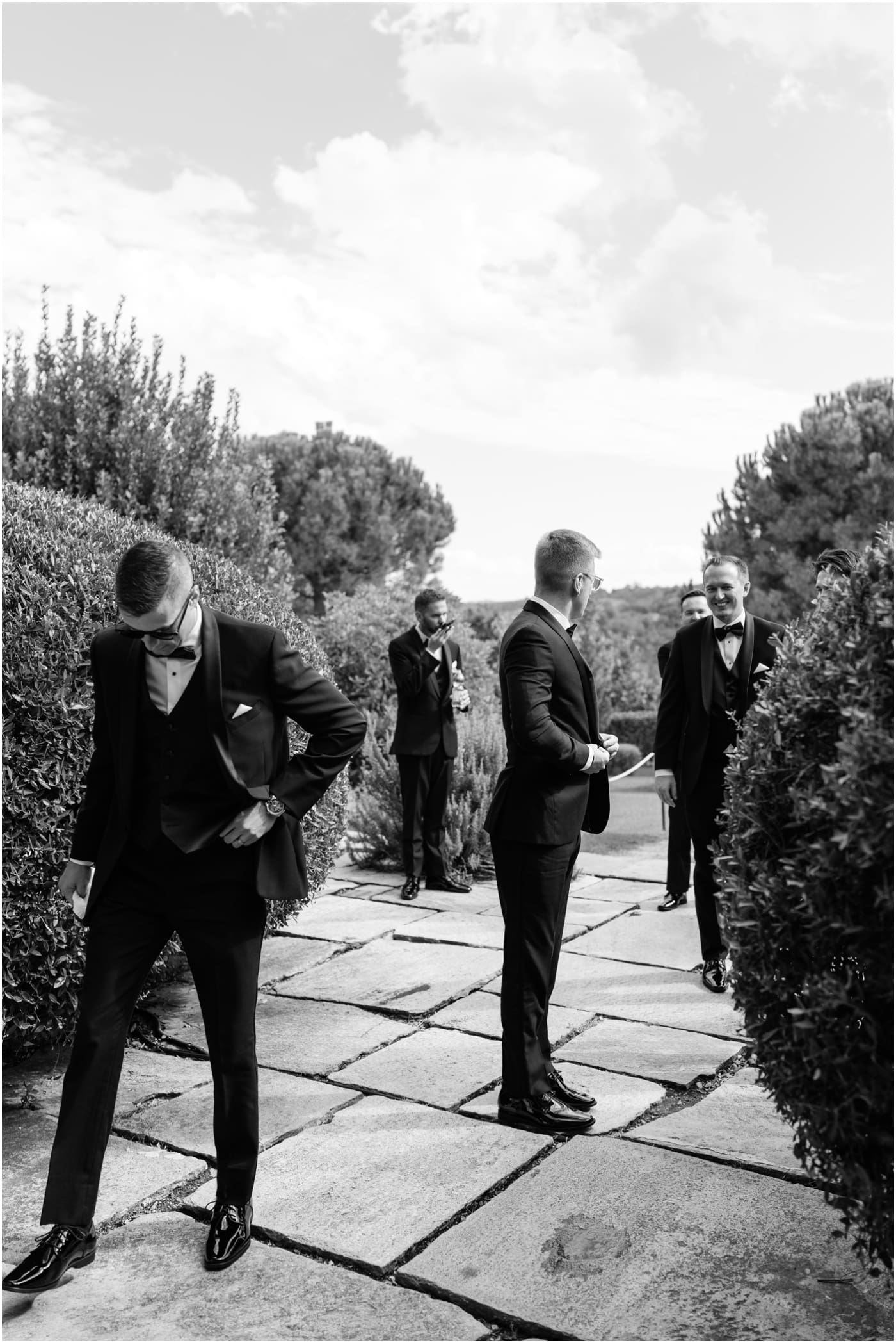 black and white candid photo of groomsmen 