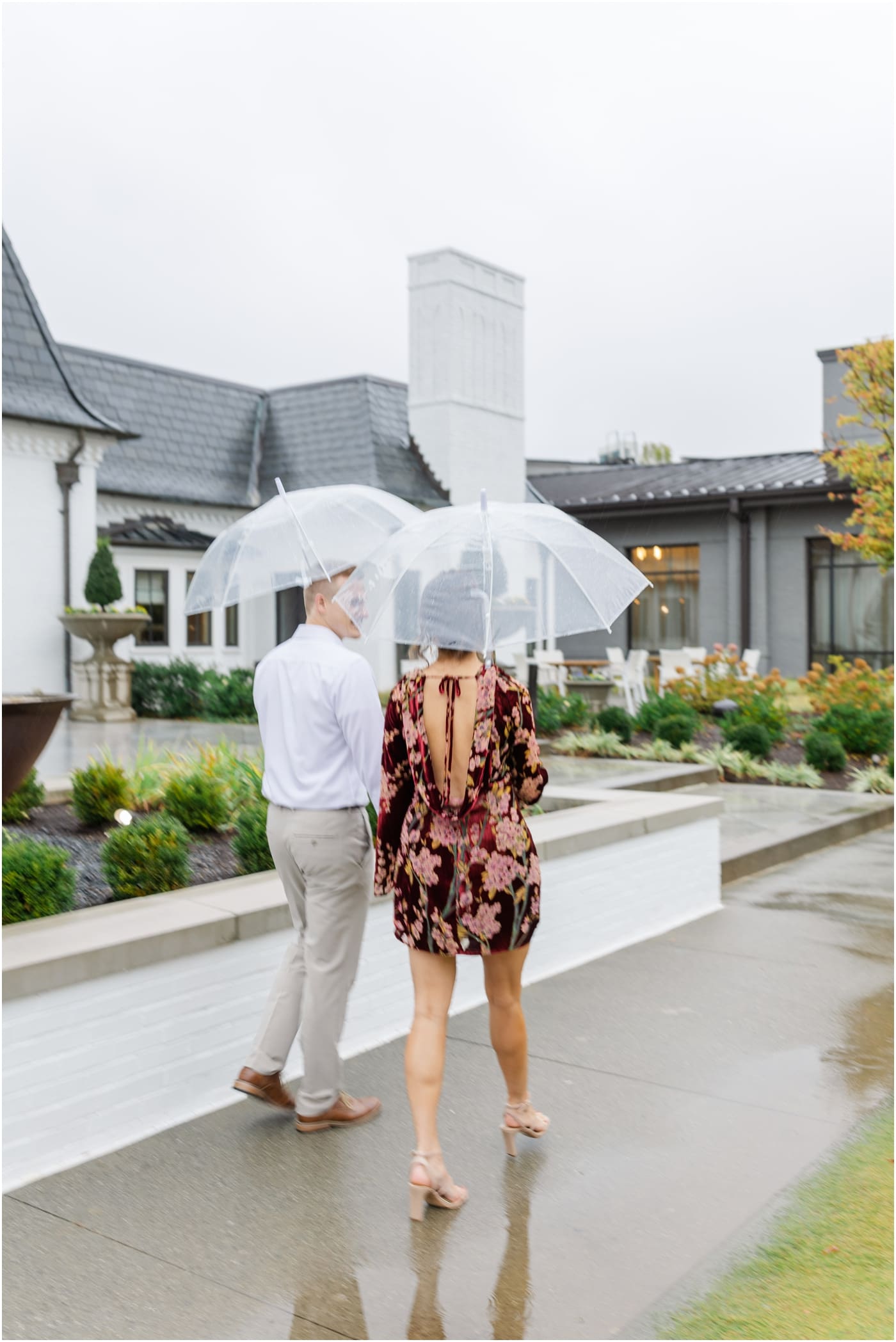 Couple under clear umbrella during a rainy hotel Hartness engagement session