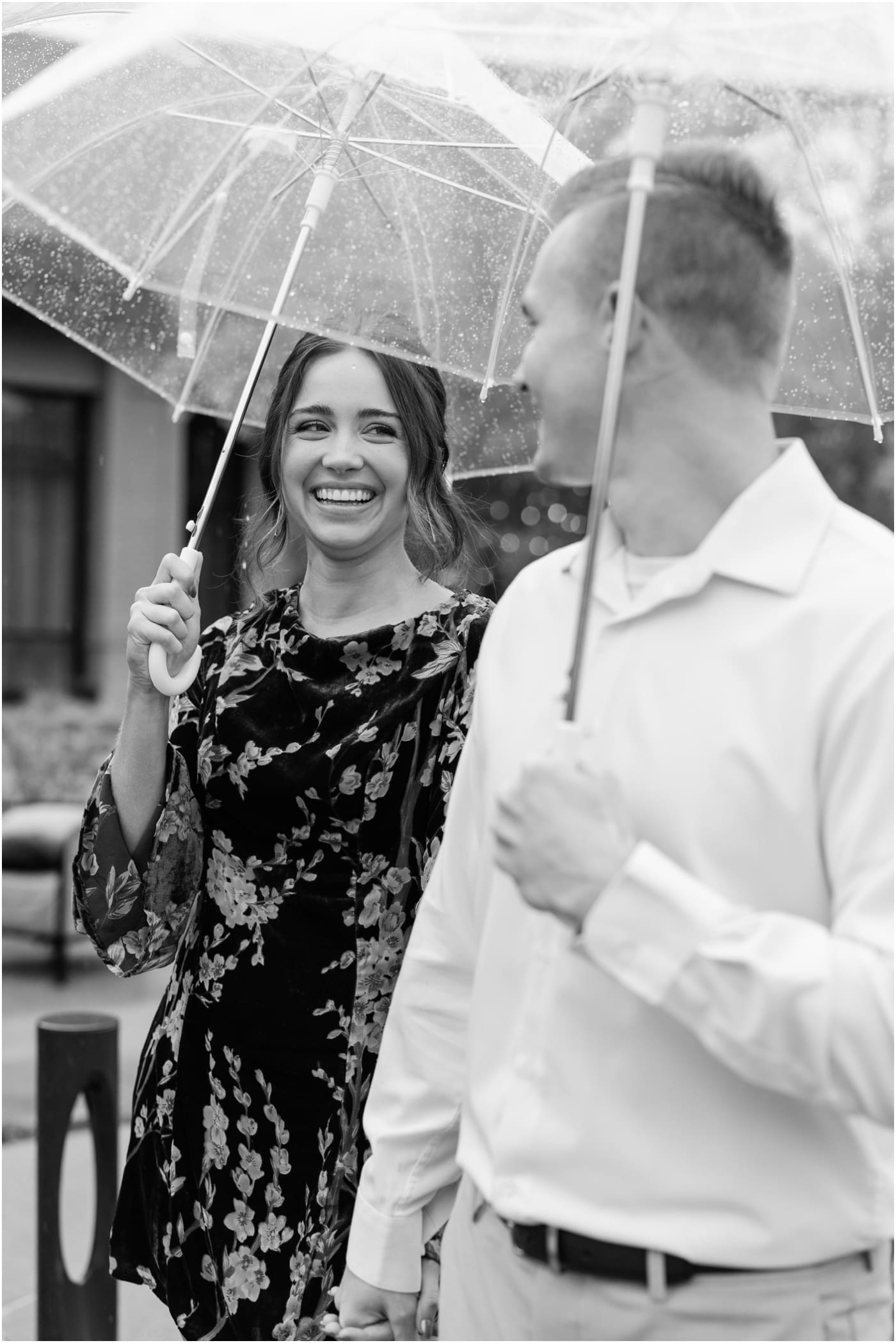 Couple under clear umbrella during a rainy hotel Hartness engagement session