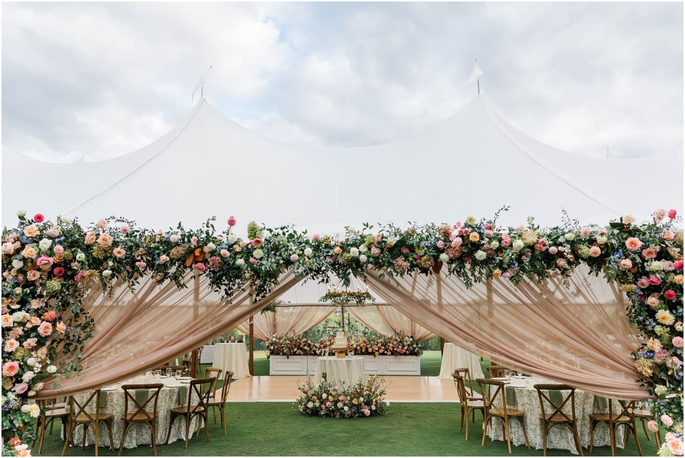 Floral arch on sailcloth tent at reserve at lake keowee wedding