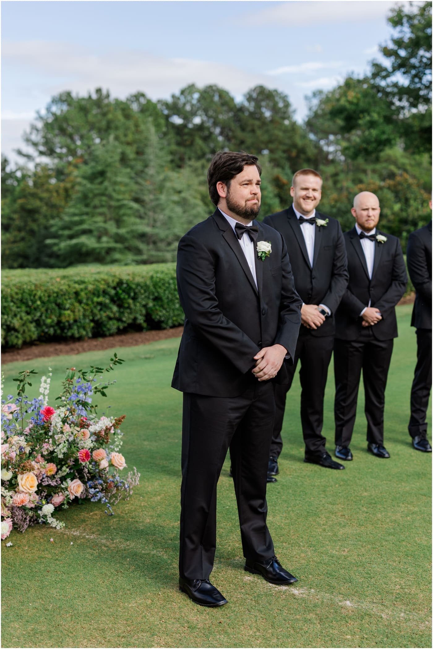 groom watching bride walk down aisle at reserve at lake keowee wedding