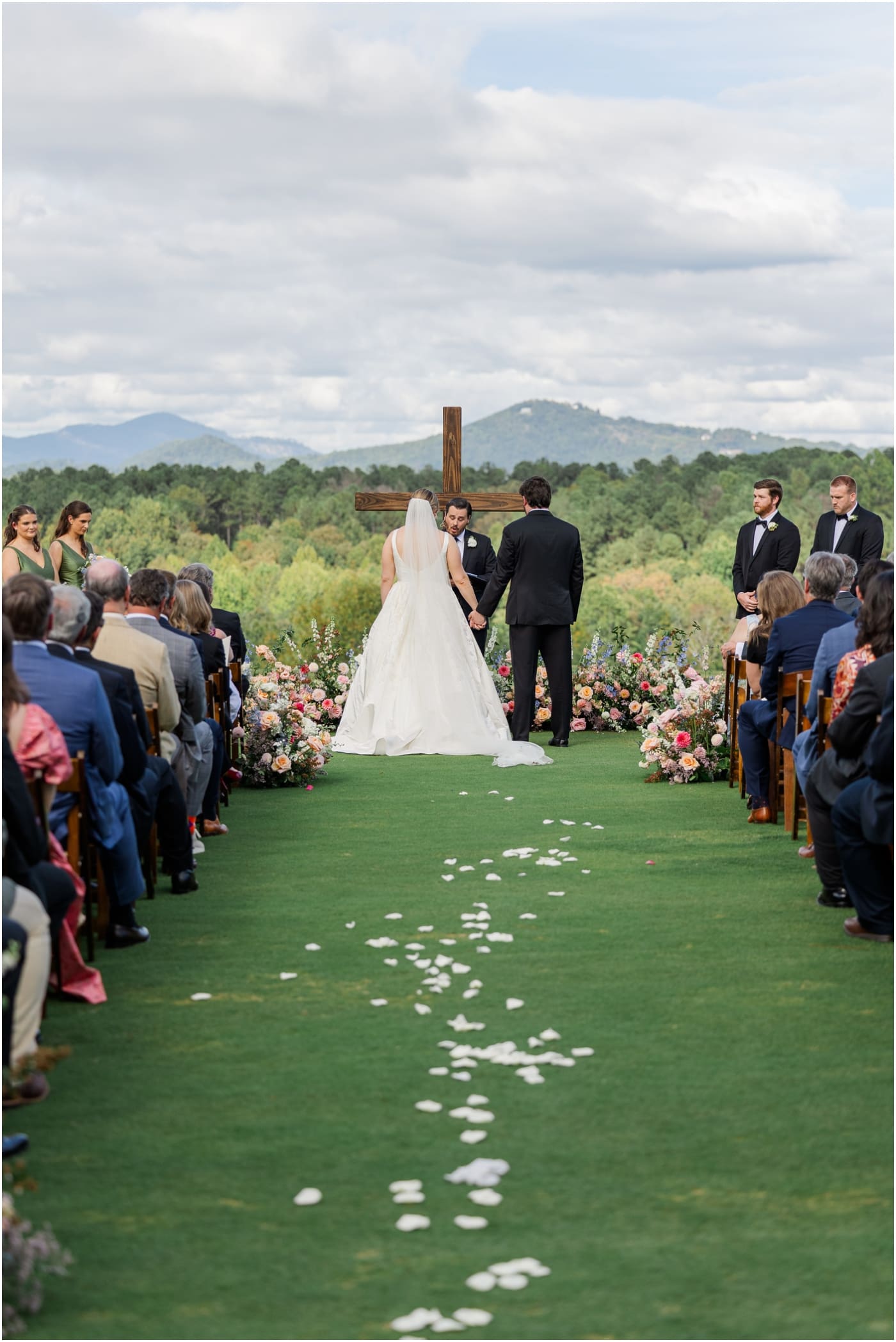 bride and groom holding hands during ceremony at reserve at lake keowee wedding