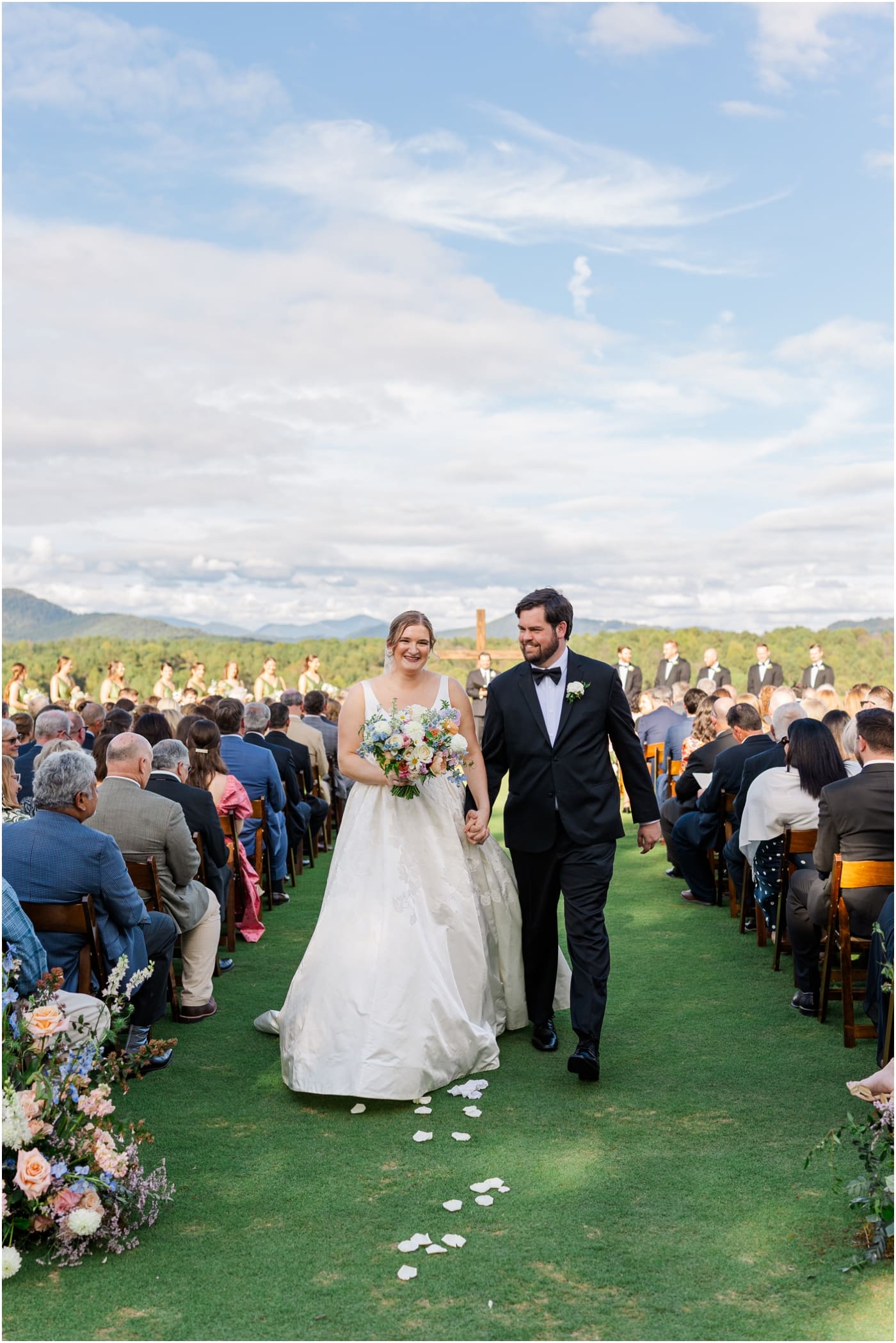 bride and groom walking up aisle after ceremony at reserve at lake keowee wedding