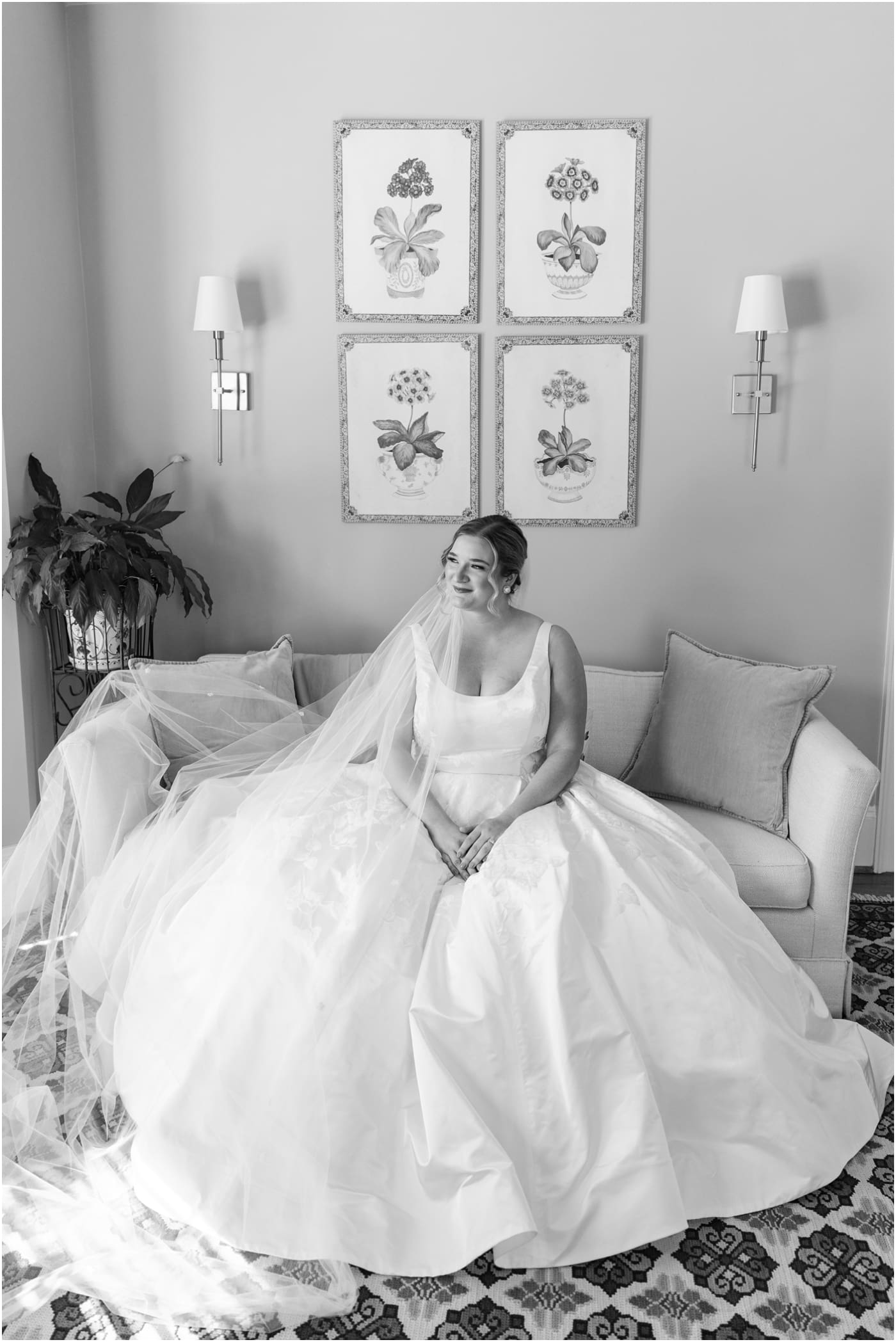 black and white bridal portrait of bride sitting on couch