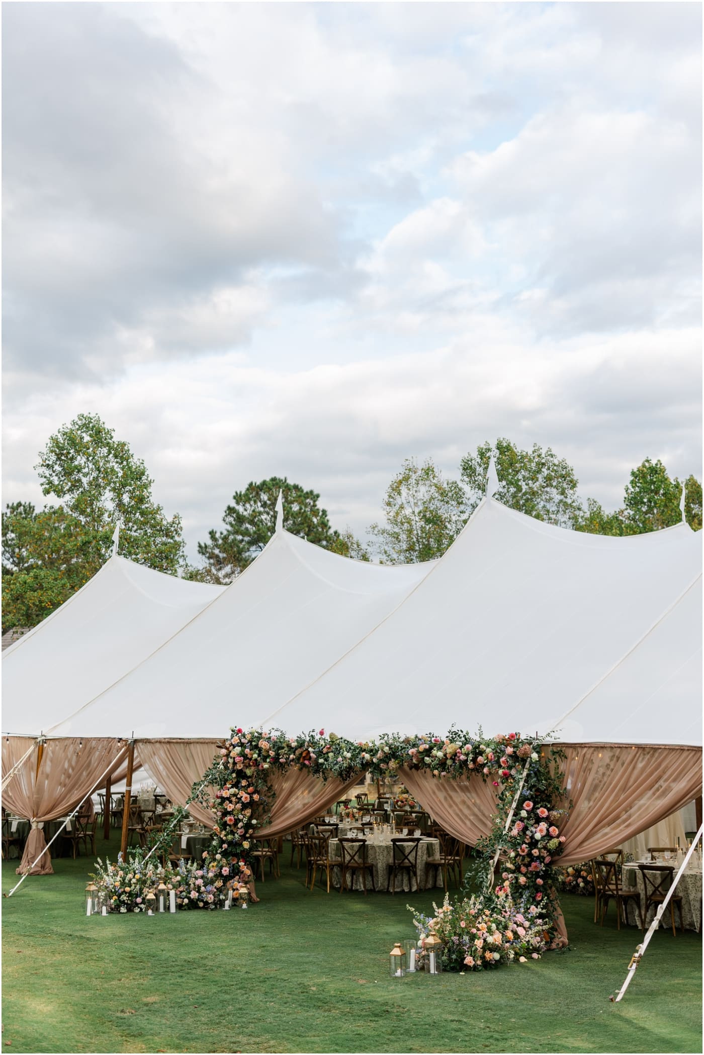 floral arch on sailcloth tent at reserve at lake keowee wedding