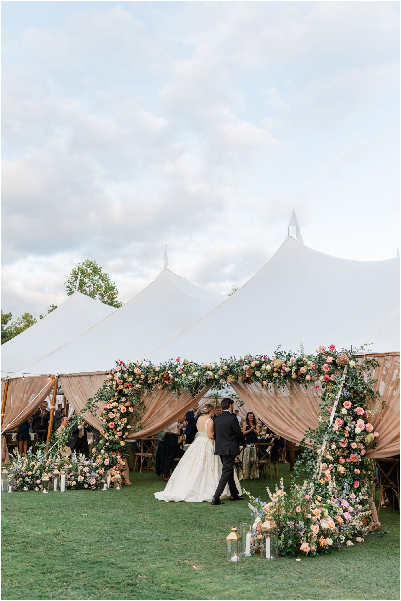 bride and groom entering sailcloth tent reception at reserve at lake keowee wedding