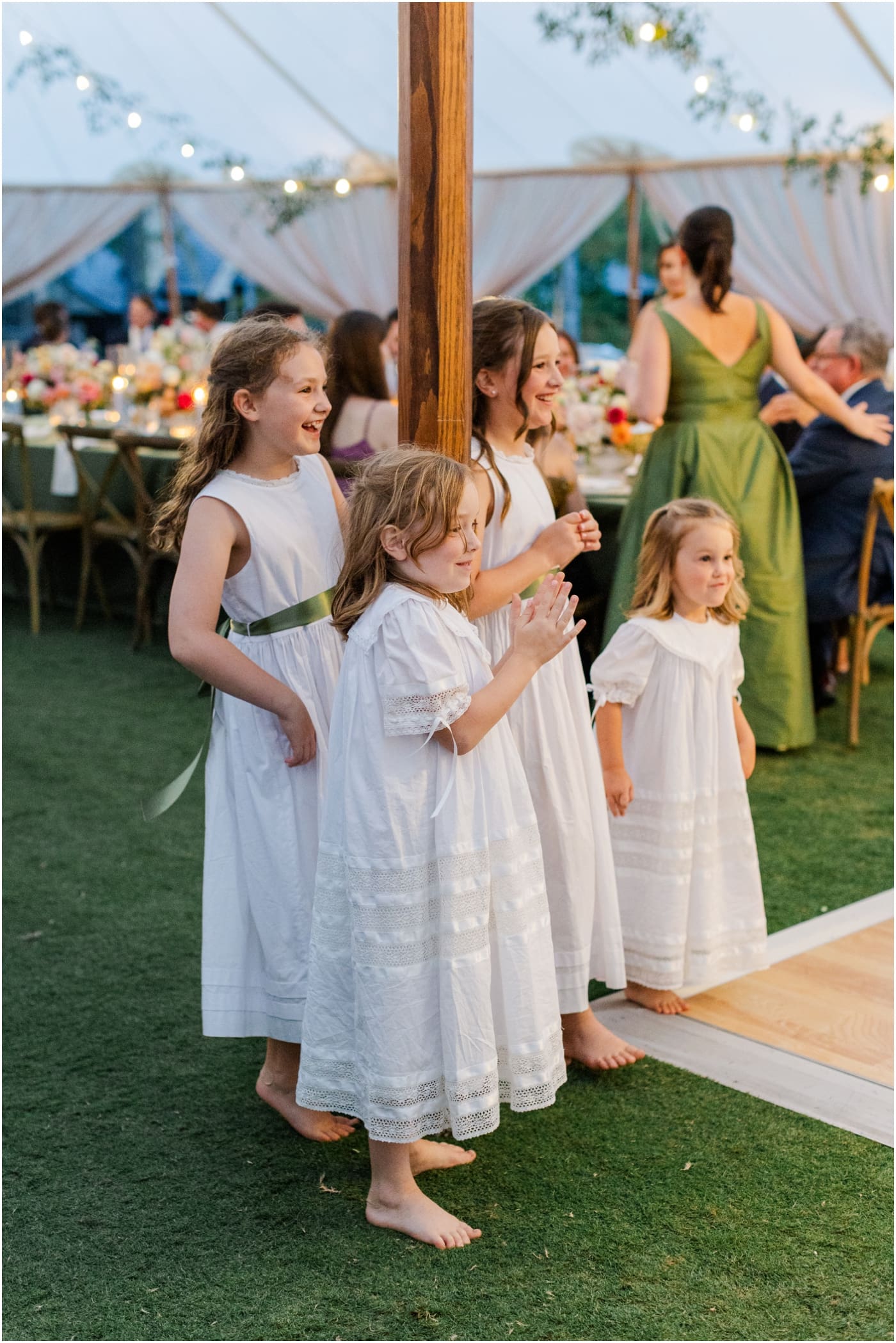 flower girls watching as bride and groom cut cake at reserve at lake keowee wedding