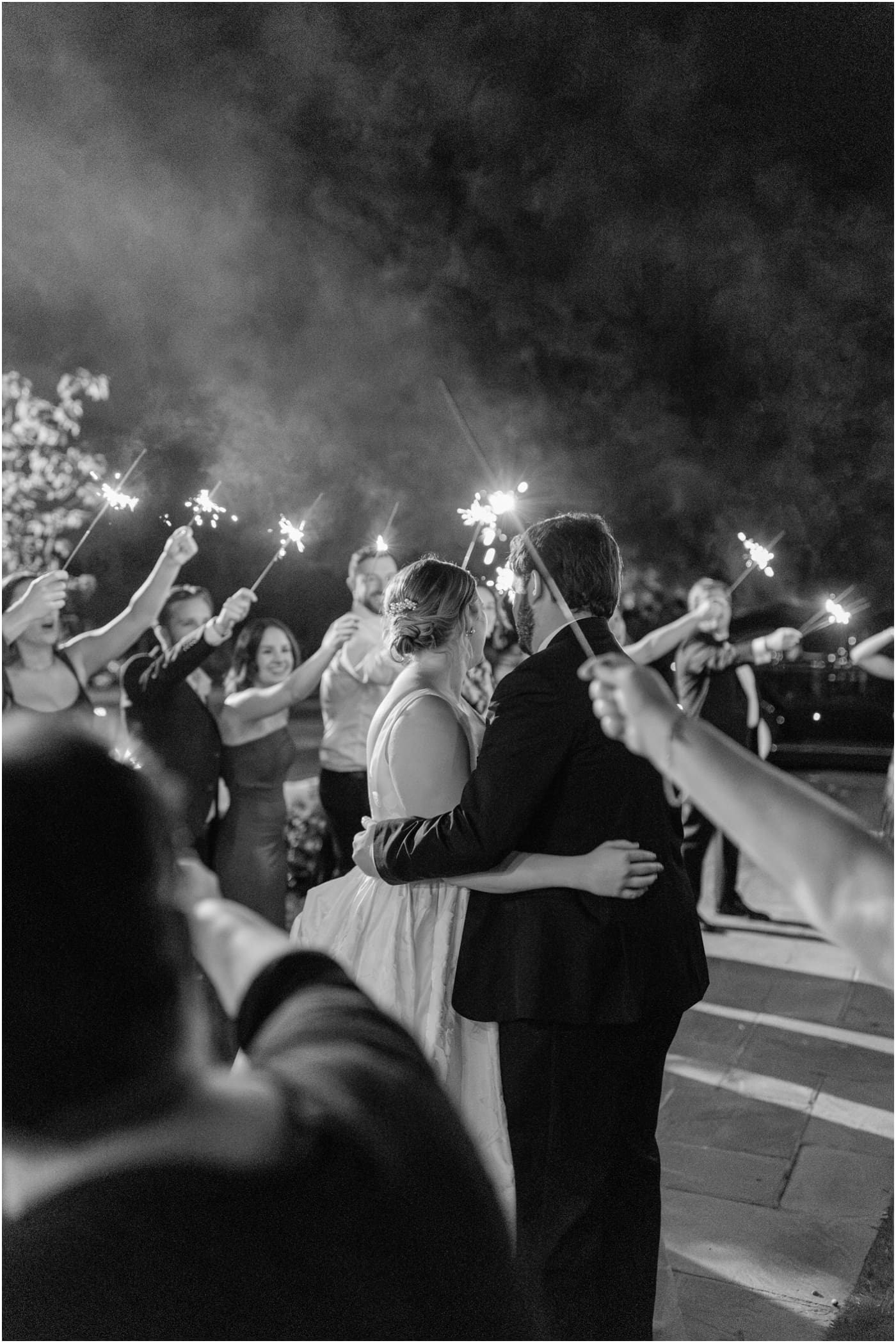 black and white photo of bride and groom during sparkler exit at Reserve at Lake Keowee Wedding